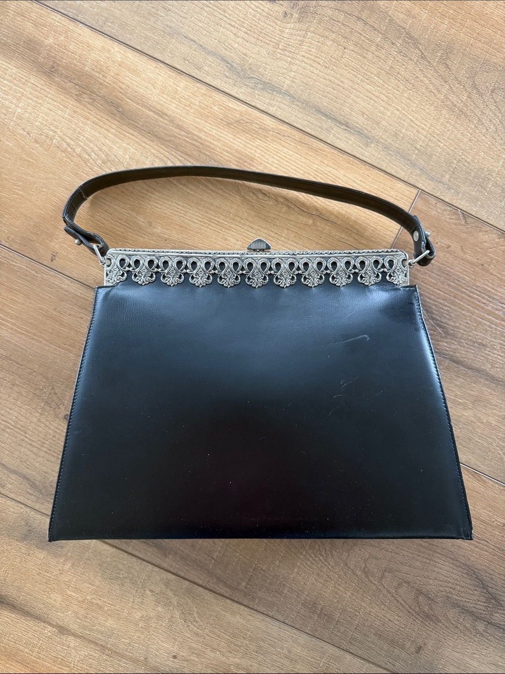 Classic Triangle Black Top-Handle Bag with Ornate Silver Frame